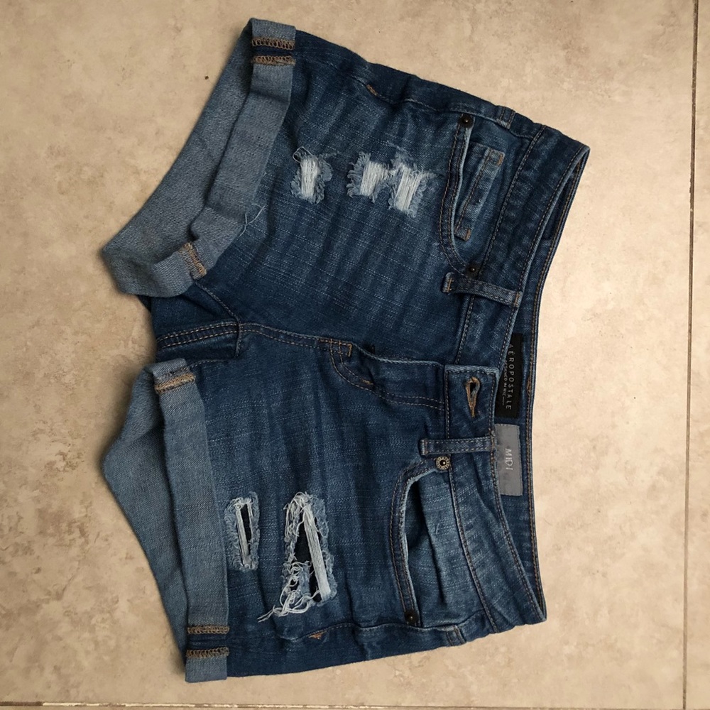 medium wash destroyed denim midi shorts